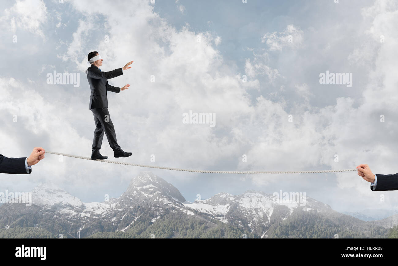 Business concept of risk support and assistance with man balancing on ...