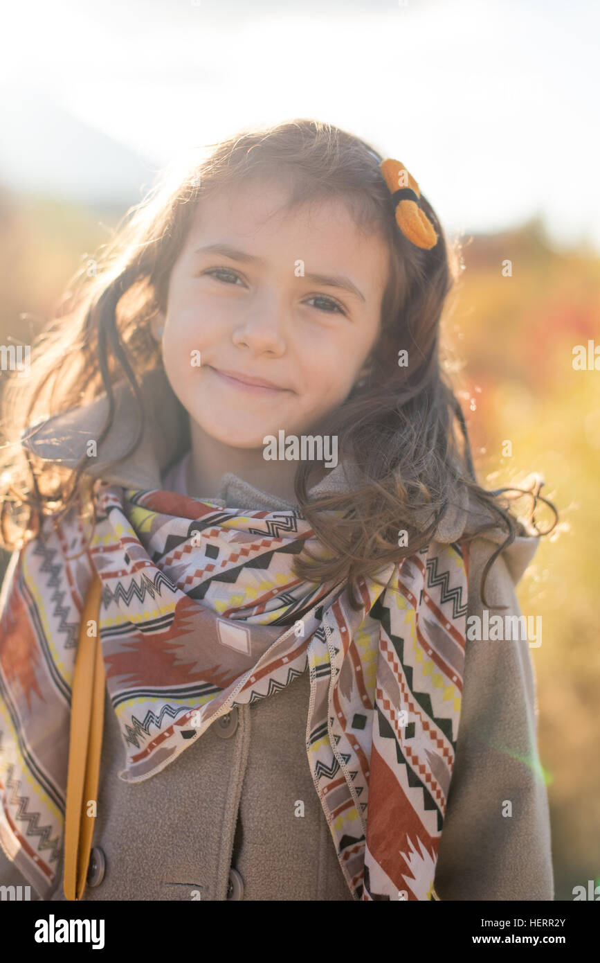 Portrait of a smiling girl in autumn sun Stock Photo
