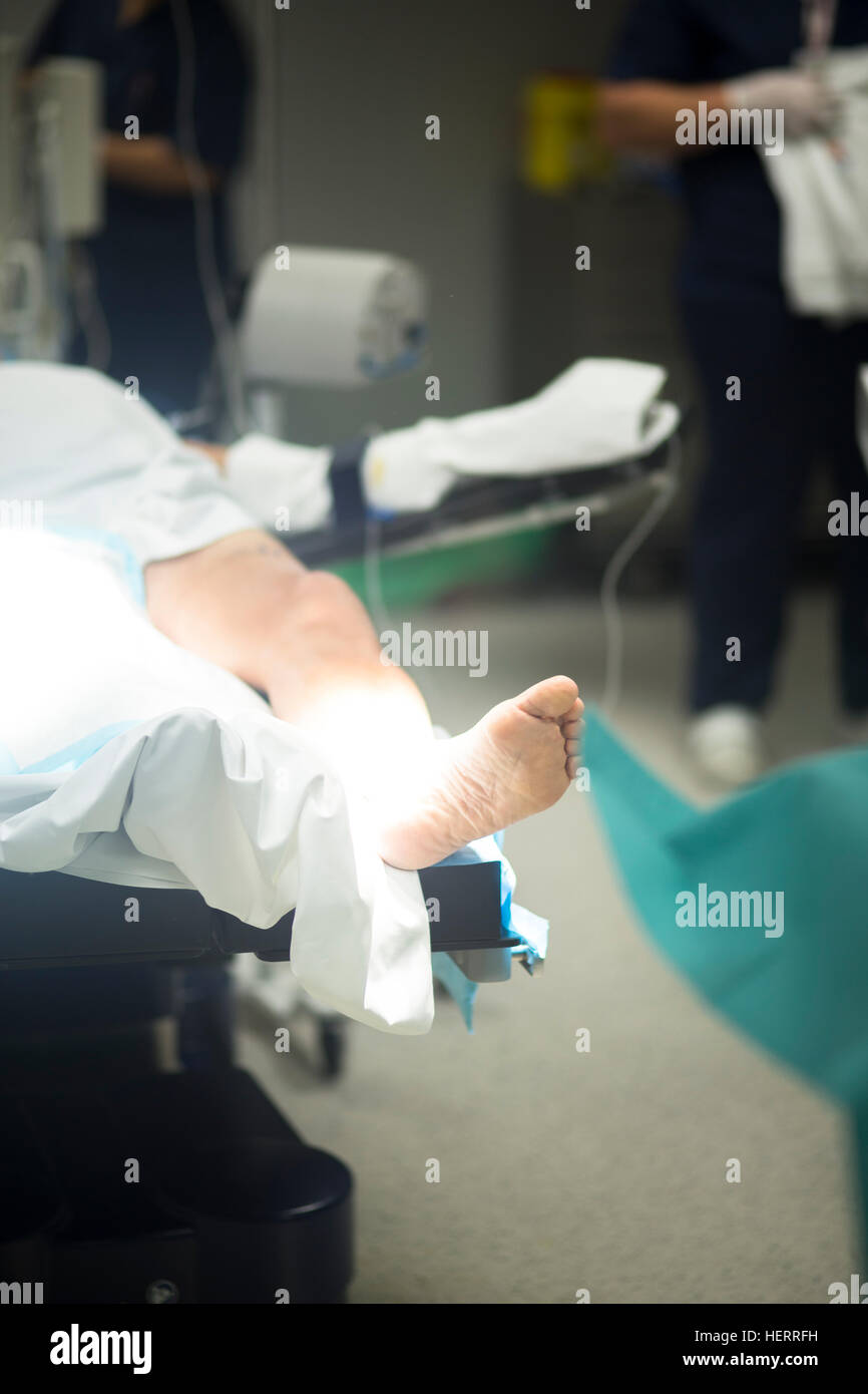 Post Operative Beding Hospital surgery bed and patient with leg bandaged post operation in ...