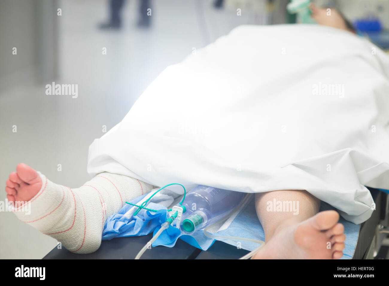 Post Operative Beding Hospital surgery bed and patient with leg bandaged post operation in ...