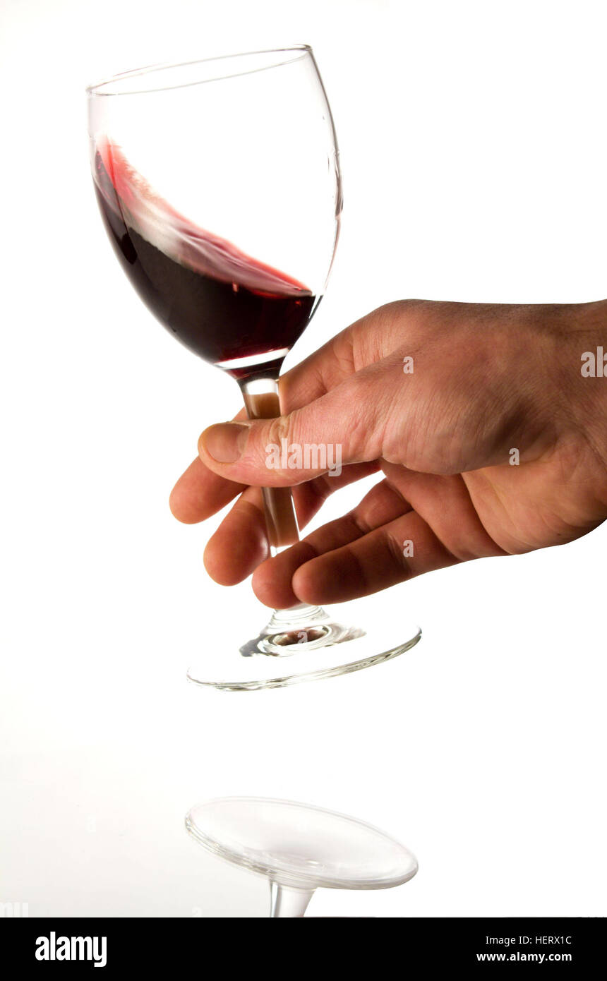 Person holding a half full glass of wine Stock Photo Alamy