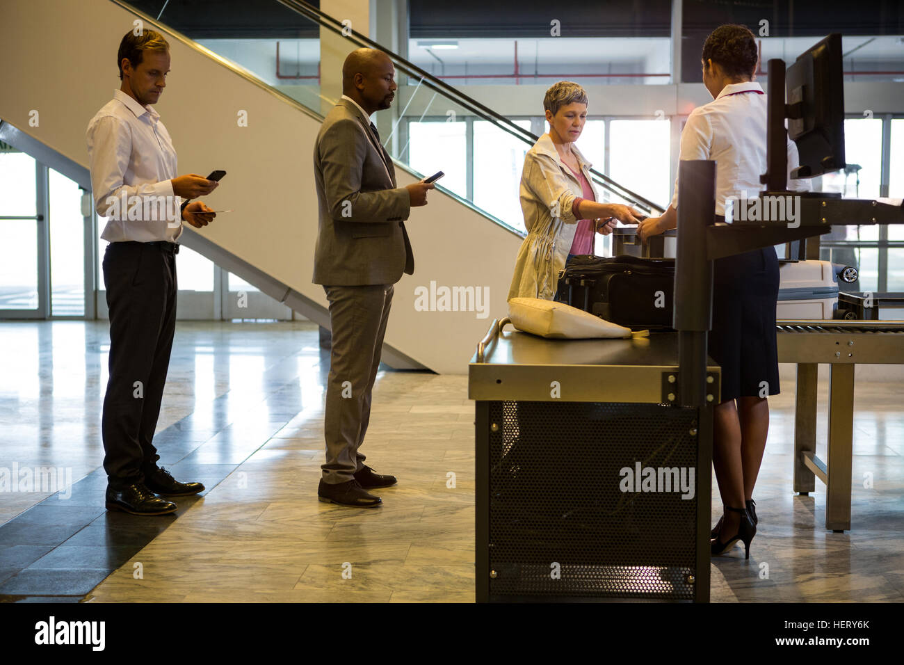 Airline checkin attendant handing boarding pass to passenger at