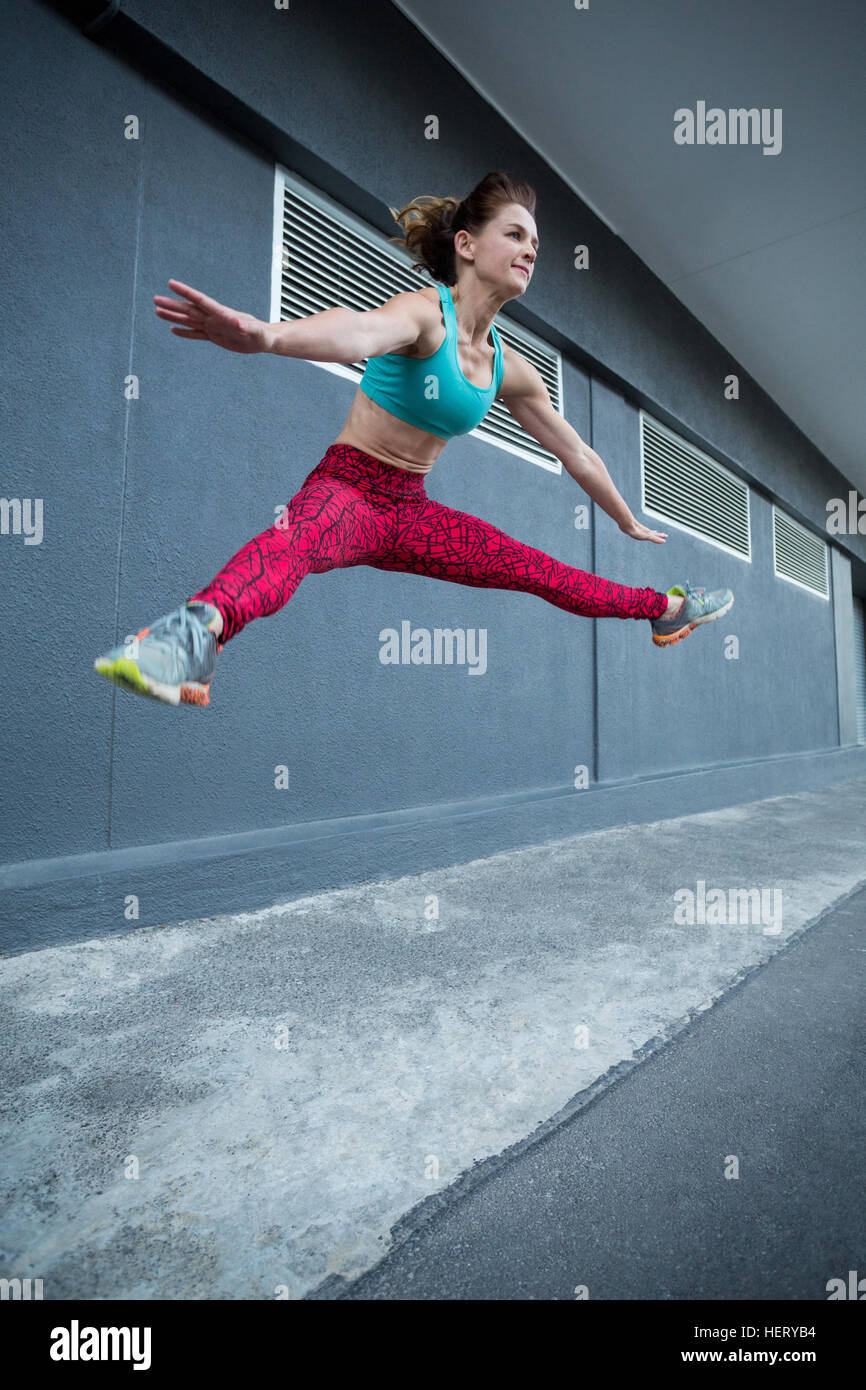 Happy sporty woman jumping hi-res stock photography and images - Alamy