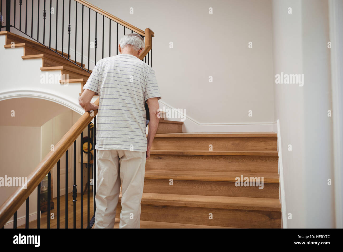 Senior man walking up stairs at home Stock Photo Alamy