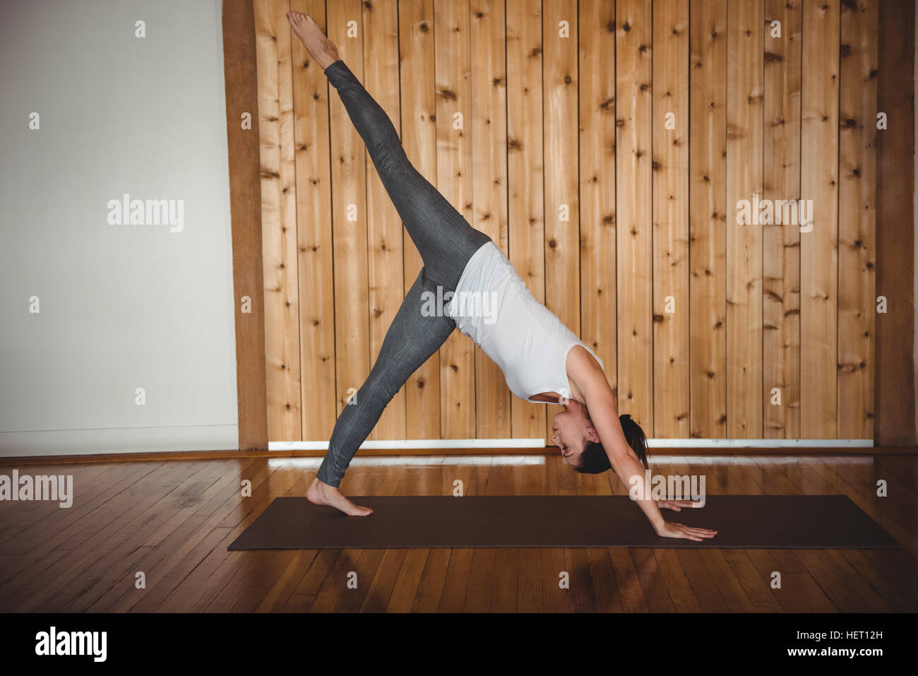 Woman practising yoga in fitness studio Stock Photo - Alamy