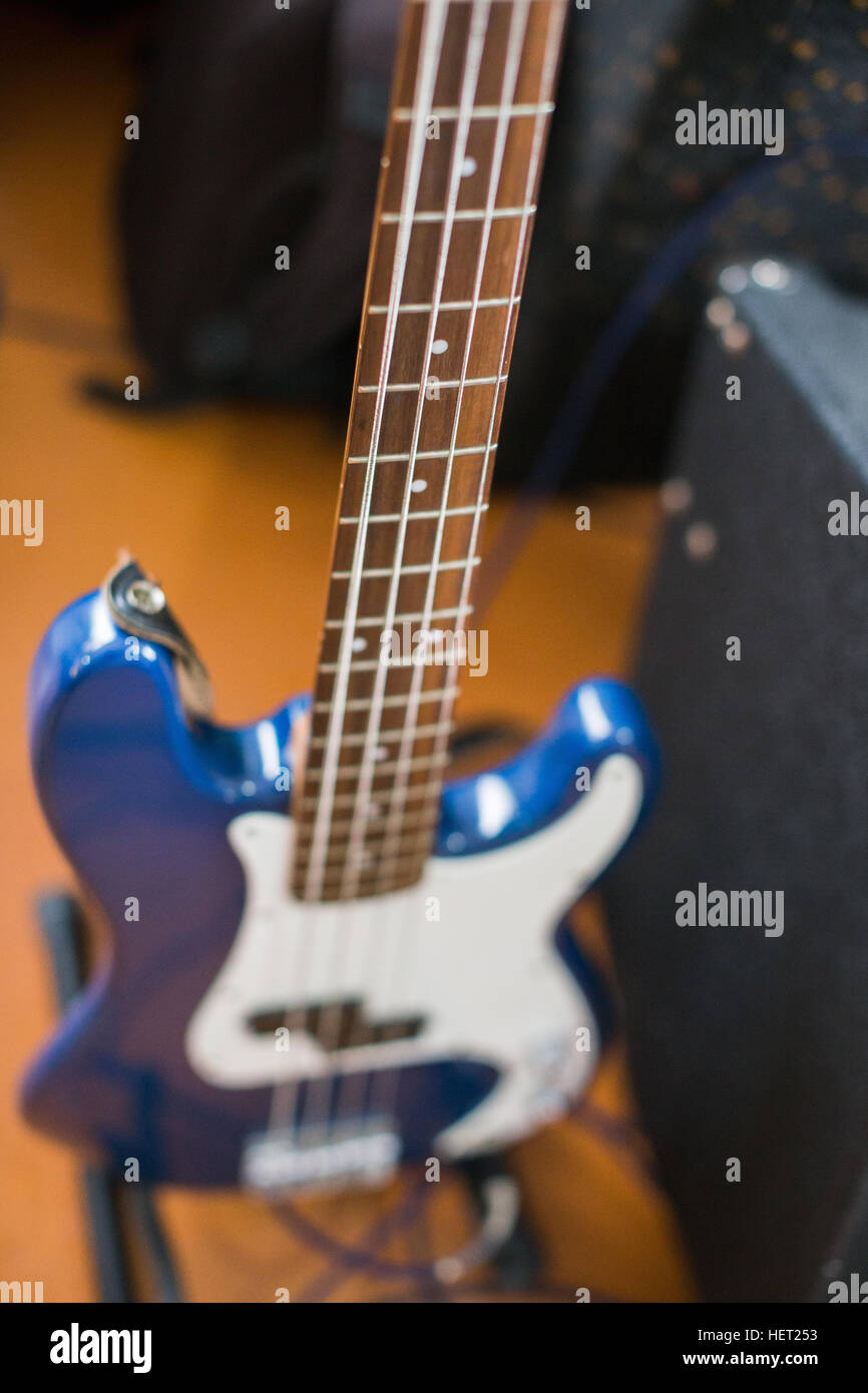 Blue electric bass guitar on the floor for recording Stock Photo - Alamy