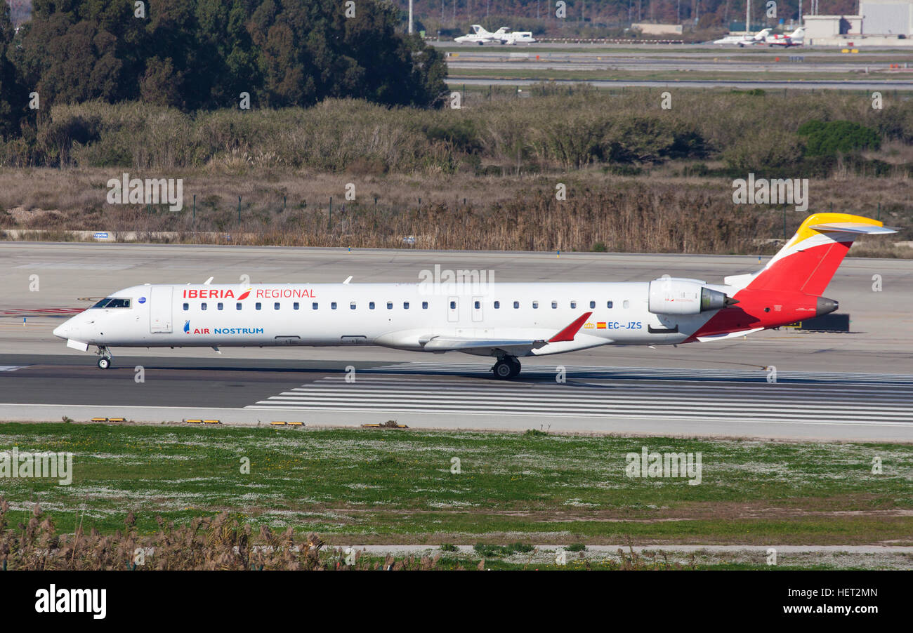 Air Nostrum Bombardier CRJ-900ER taxiing along the runway at El Prat Airport in Barcelona, Spain. Stock Photo