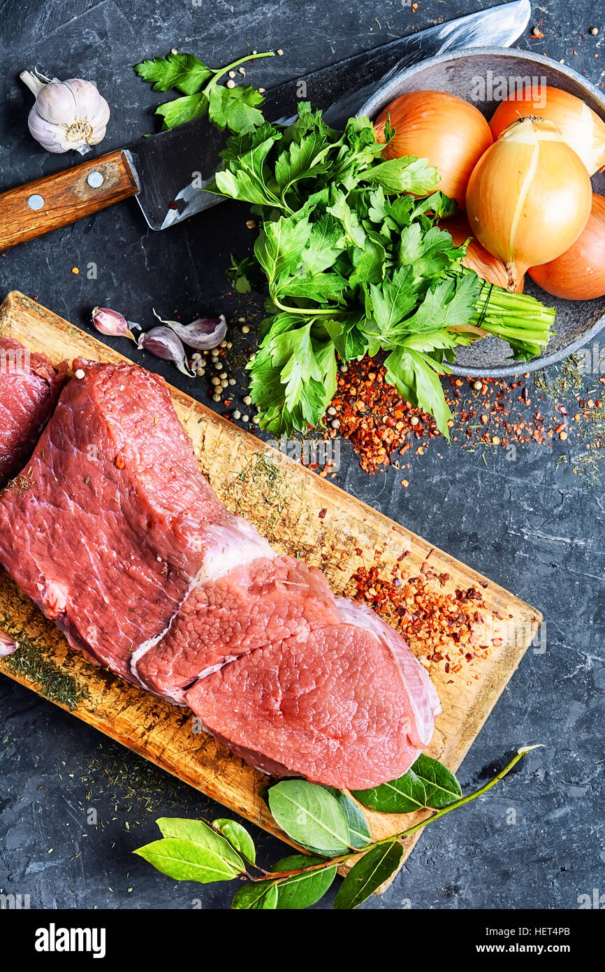 Raw veal meat on kitchen board with spice Stock Photo Alamy