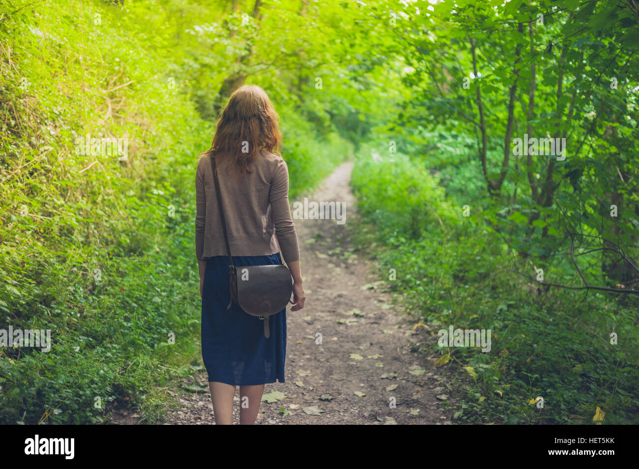 A young woman is walking in a forest Stock Photo - Alamy