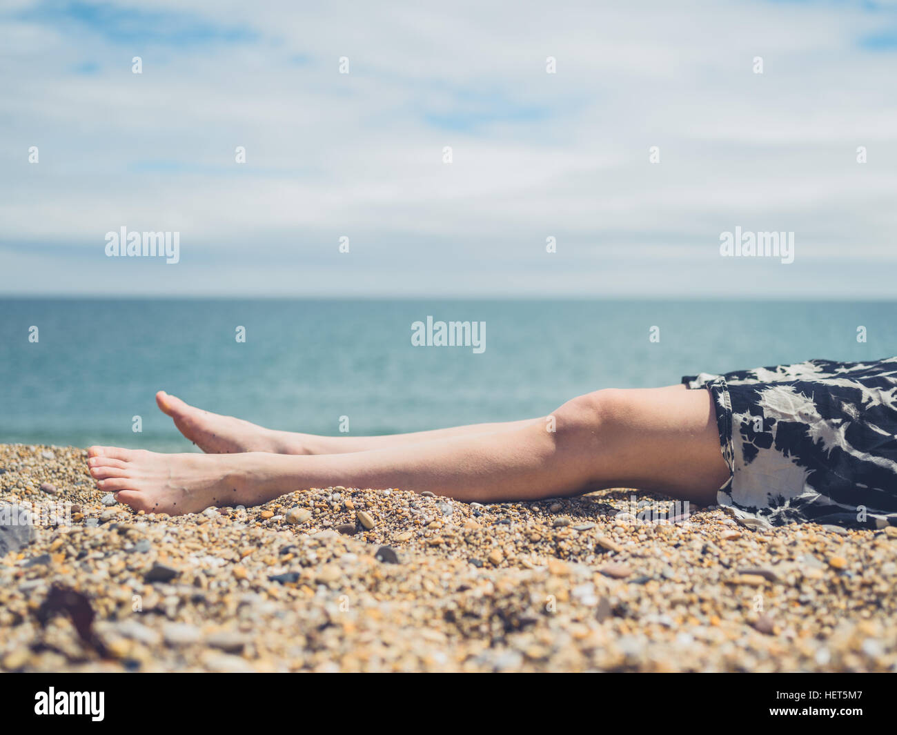 Woman legs beach lying hi-res stock photography and images