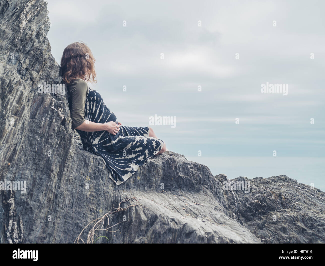 Portrait of sexy young Caucasian woman sitting on rocky coast with breasts  exposed, Stock Photo, Picture And Royalty Free Image. Pic. LPX-U21736378