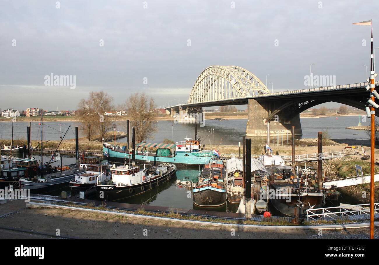 Waalbrug (1936), 600m long arch bridge over the Waal River in Nijmegen, Gelderland, Netherlands. Lindenberghaven at Waalkade Stock Photo