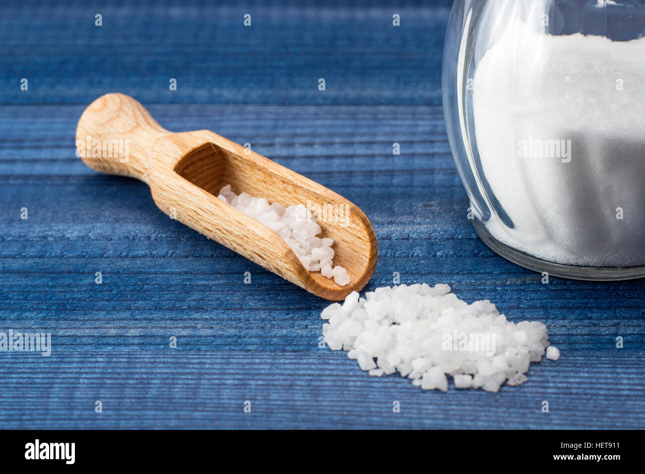 Salt with wooden spoon and glass salt shaker Stock Photo