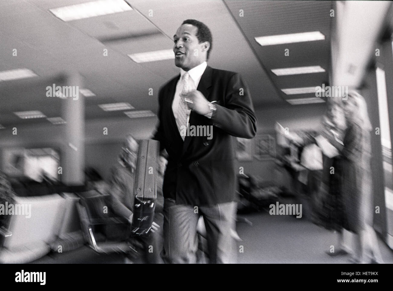 Athlete,spokesman and later - accused double murder O. J Simpson runs through an airport terminal during a filming of a television ad at the Atlanta Airport. Simpson was the face of Hertz Car Rental for many years. Stock Photo
