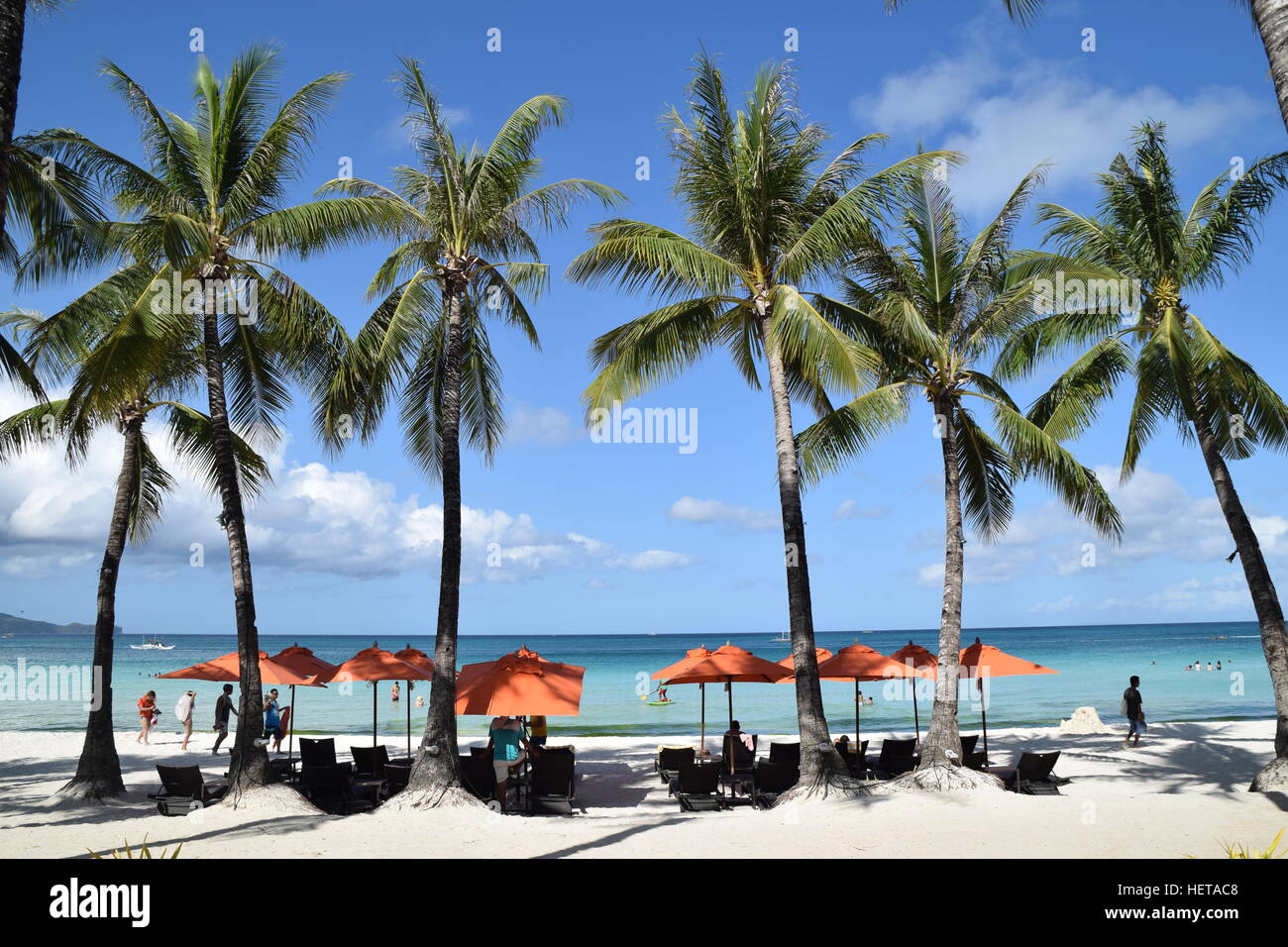 Palm trees and beach umbrellas on White Beach, Boracay island
