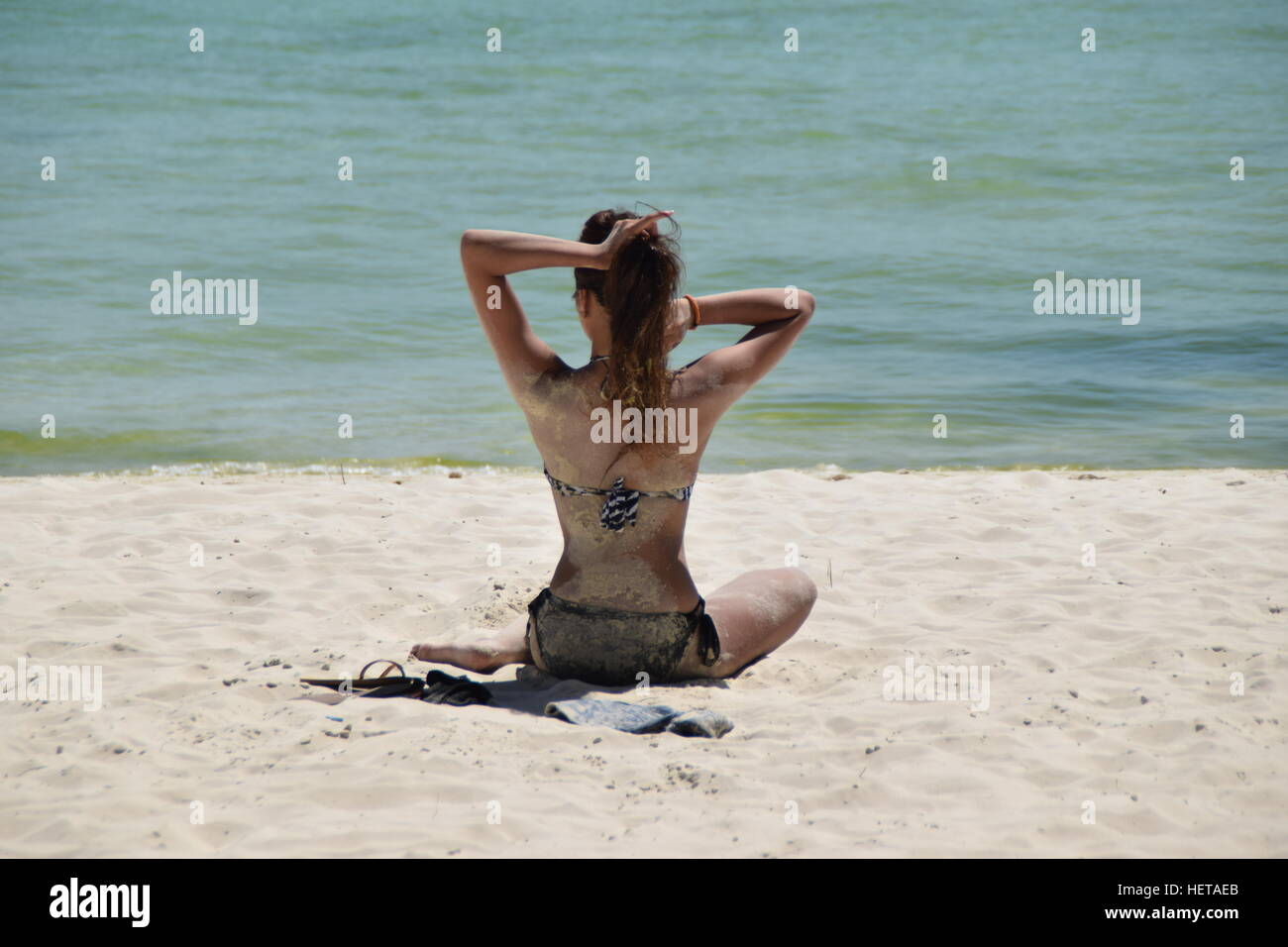 Young girl sitting on White Beach on Boracay, Philippines Stock Photo