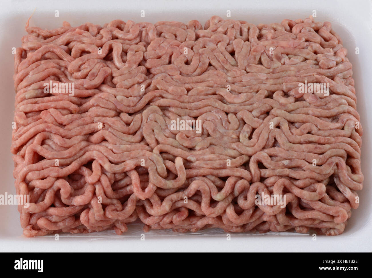 Close up of raw ground chuck beef hamburger meat in butcher polystyrene
