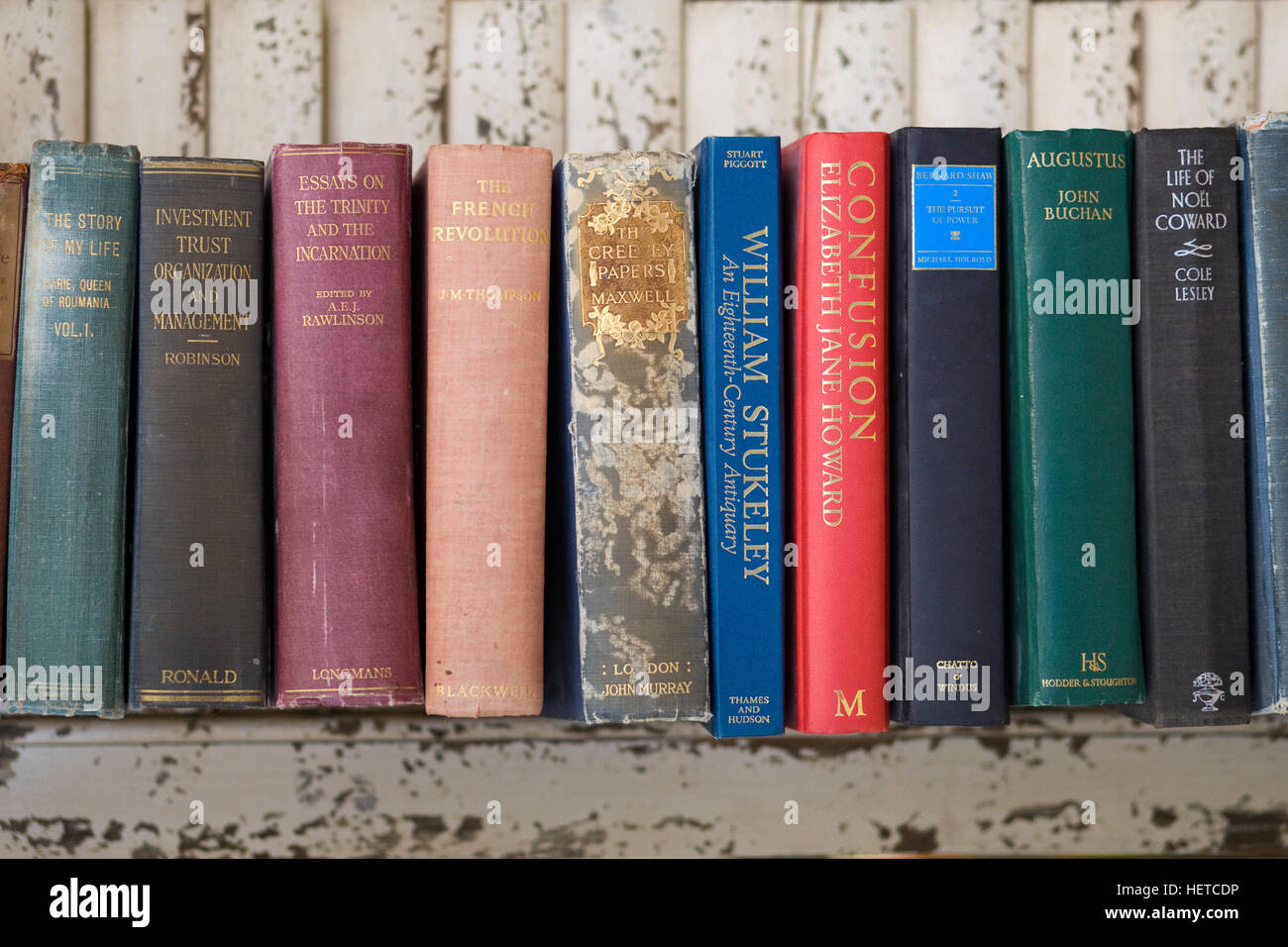 Old books on a wooden shelf Stock Photo