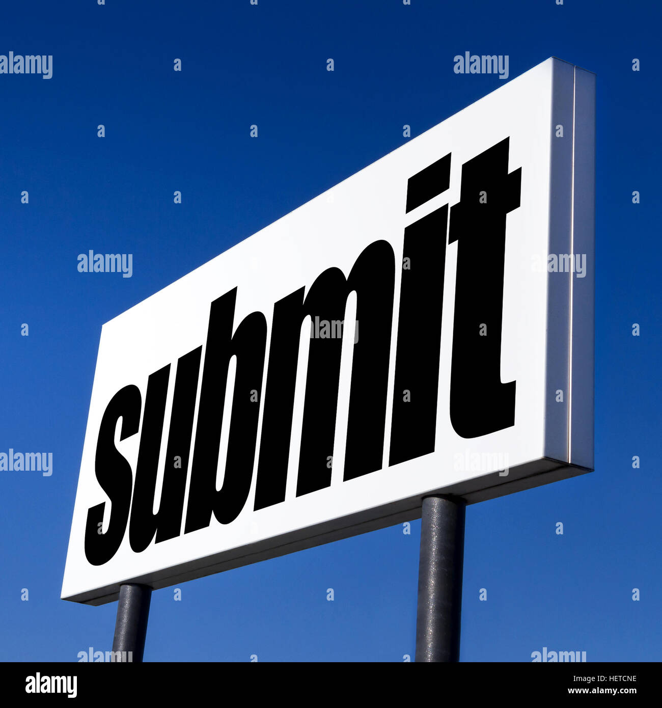 Horizontal billboard with the order to submit, against unreal blue sky. Abstract concept of consumerism, human mind control, power of corporations Stock Photo