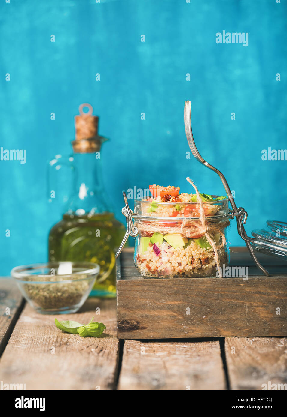 Healthy homemade jar quinoa salad with tomatoes, avocado, fresh basil Stock Photo