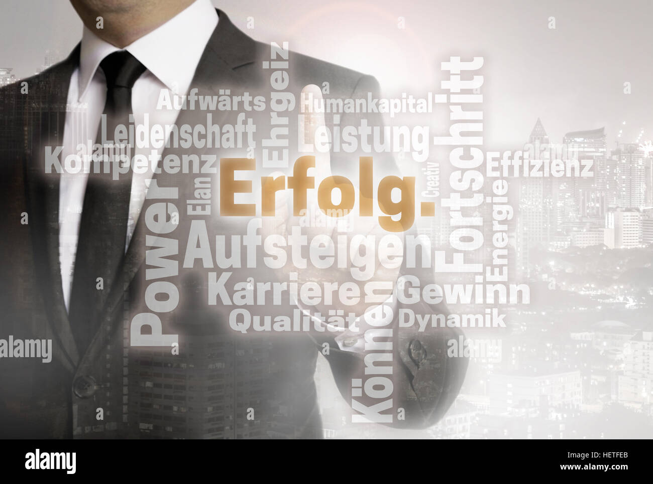 Businessman with urban background Erolg (in german success) wordcloud. Stock Photo