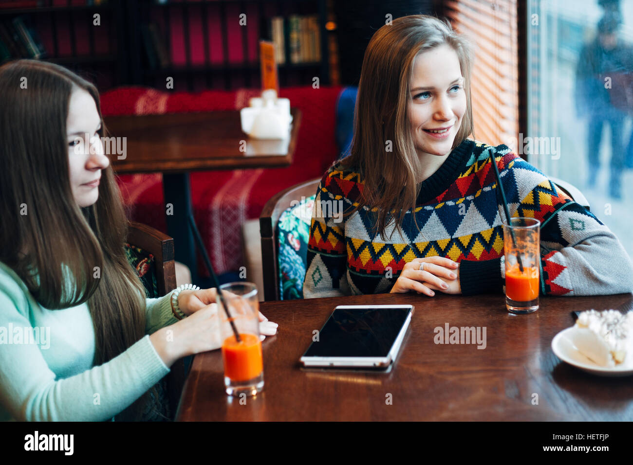 Girl friends communicate in a cafe Stock Photo