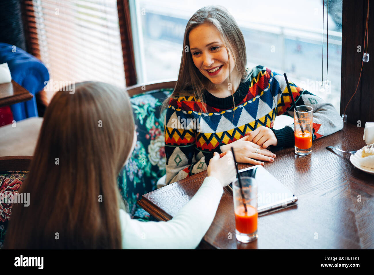 Girl friends communicate in a cafe Stock Photo