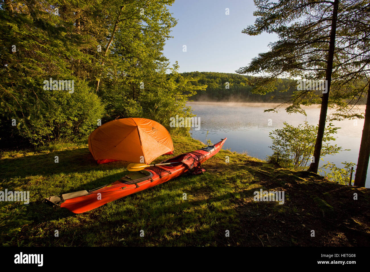 A kayak and a tent next to the Androscoggin River at a remote campsite at Mollidgewock State