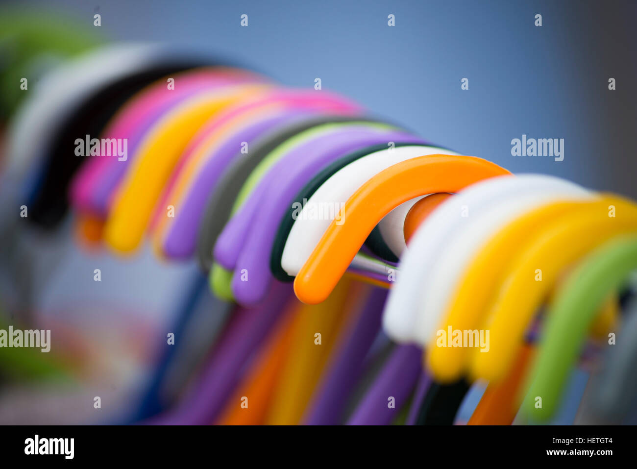Rail of multi coloured coat hangers Stock Photo Alamy
