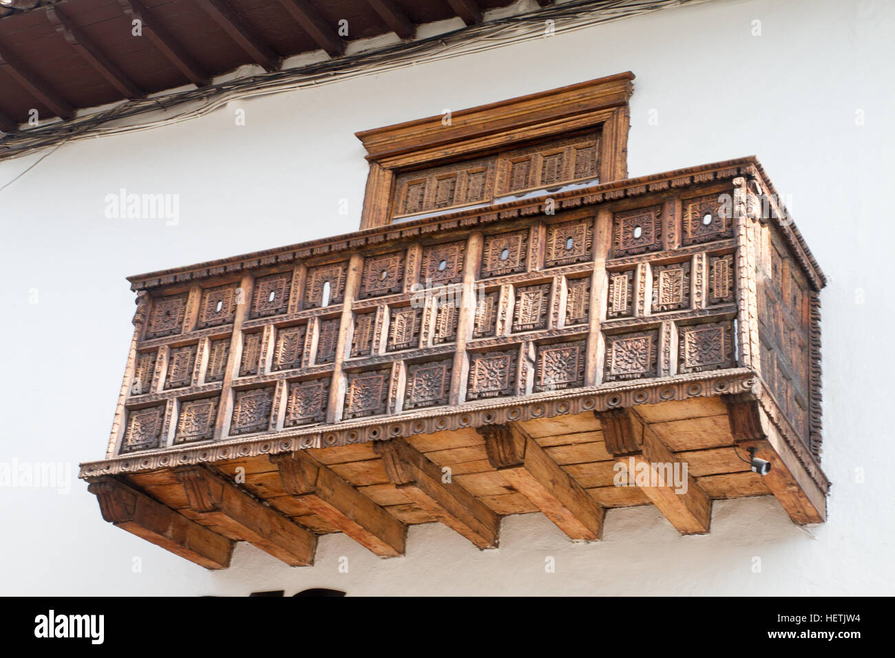 CUSCO - SEPTEMBER 02: Wooden sculptural wooden balcony architectural detail on building on the streets of Cusco, Peru on September 2nd, 2016. Stock Photo