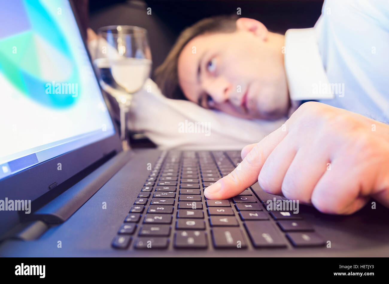 Tired businessman on the office desk during work. Stock Photo