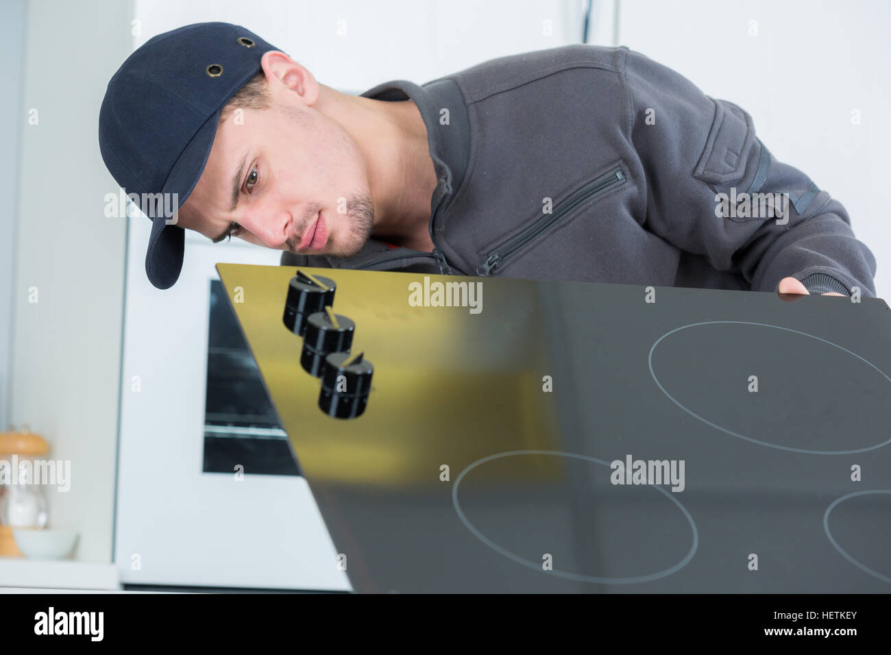 Man installing cooking hob Stock Photo Alamy