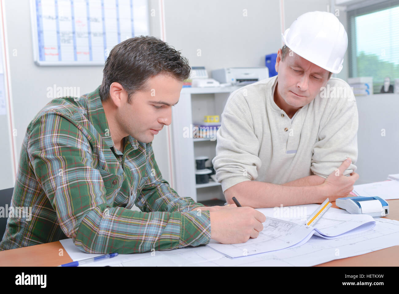 Architect explaining something to his boss Stock Photo - Alamy