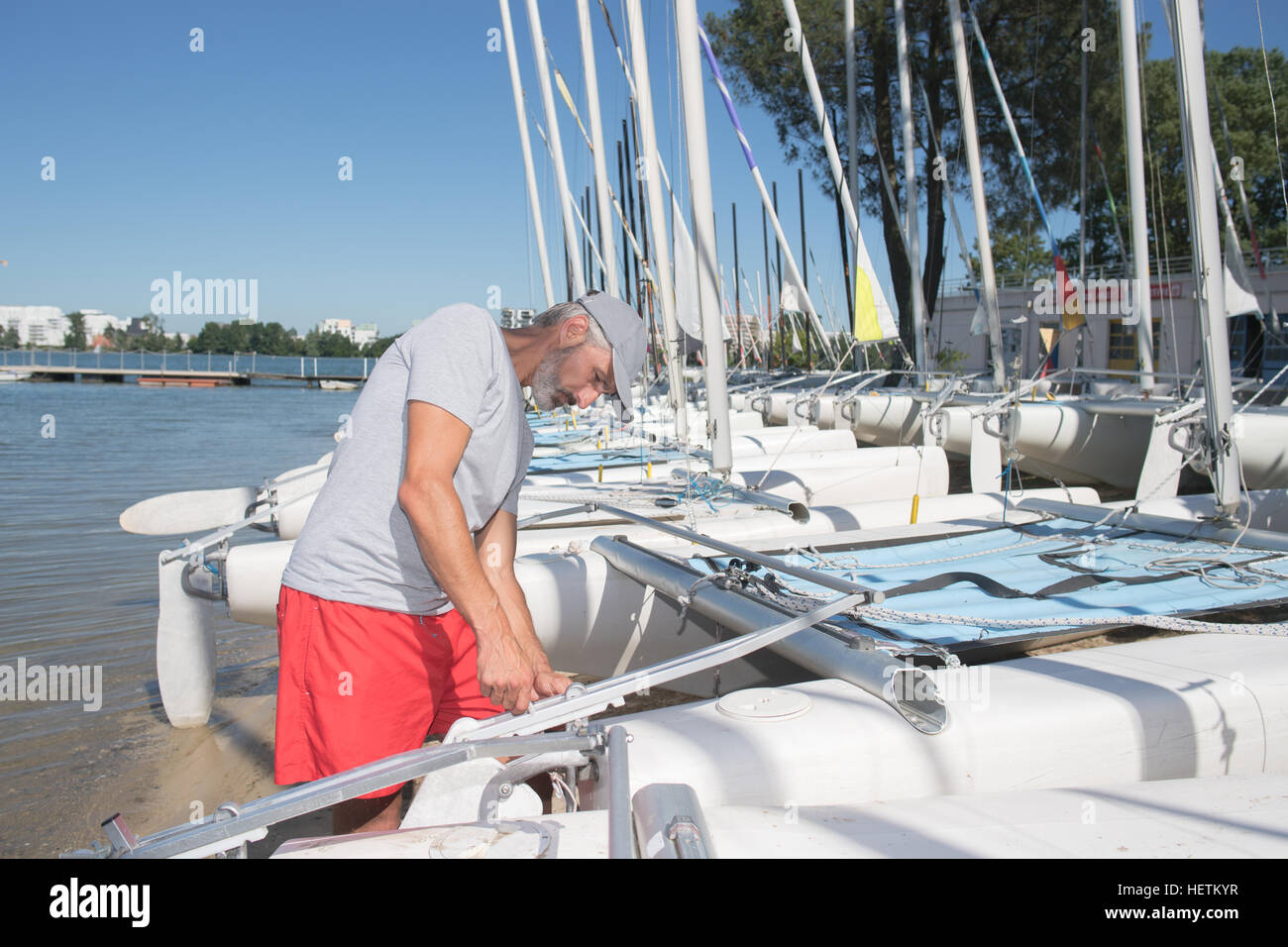 attractive sailor rigging hobbie-cat before sailing course Stock Photo