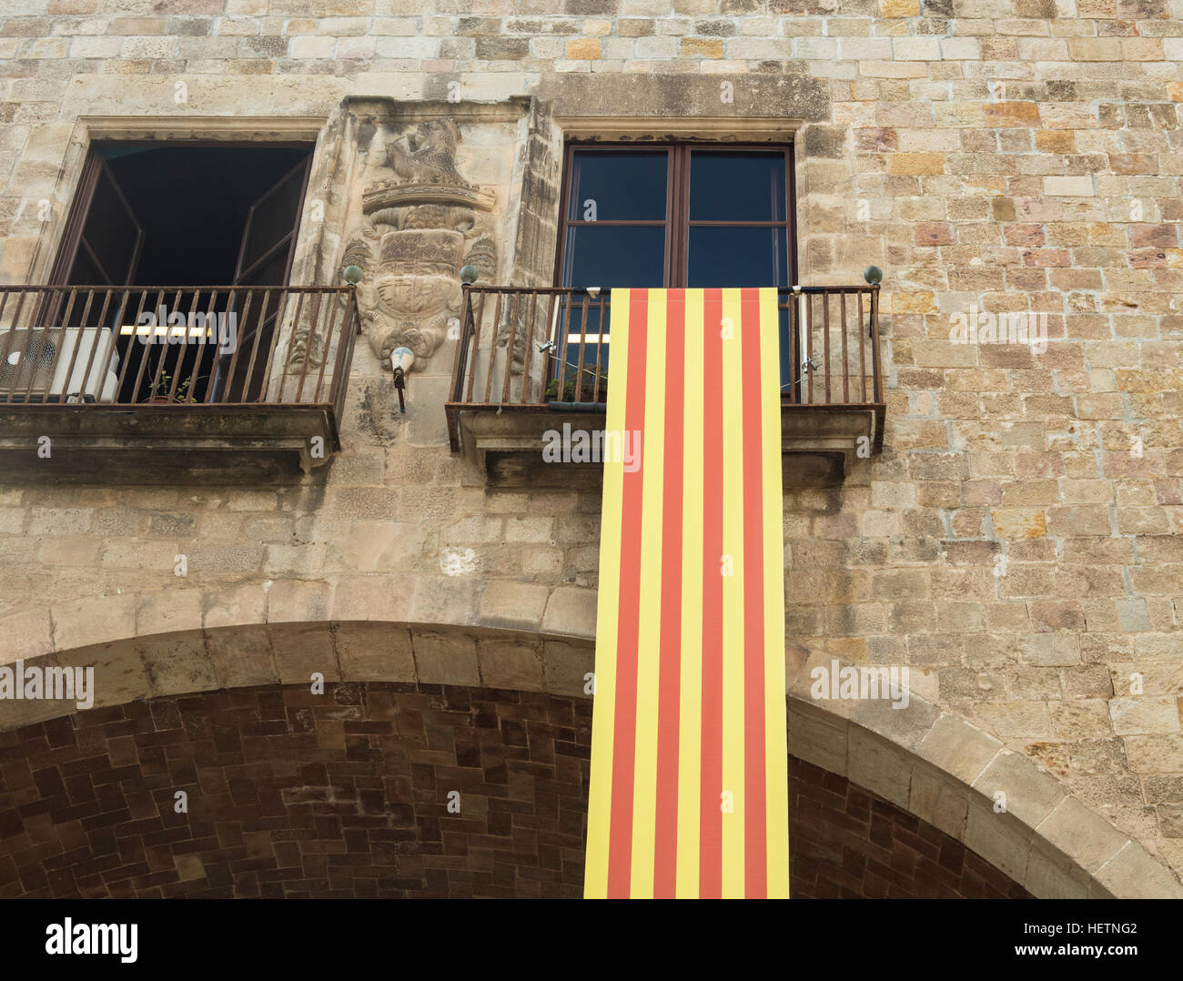 Detail of national flag of Catalonia hanging on a balcony from the National Library of Catalonia in Raval, Barcelona. Stock Photo