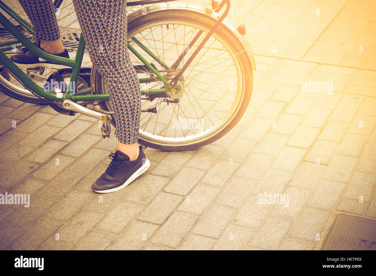 woman on a vintage bicycle wating to ride in Barcelona, Spain Stock