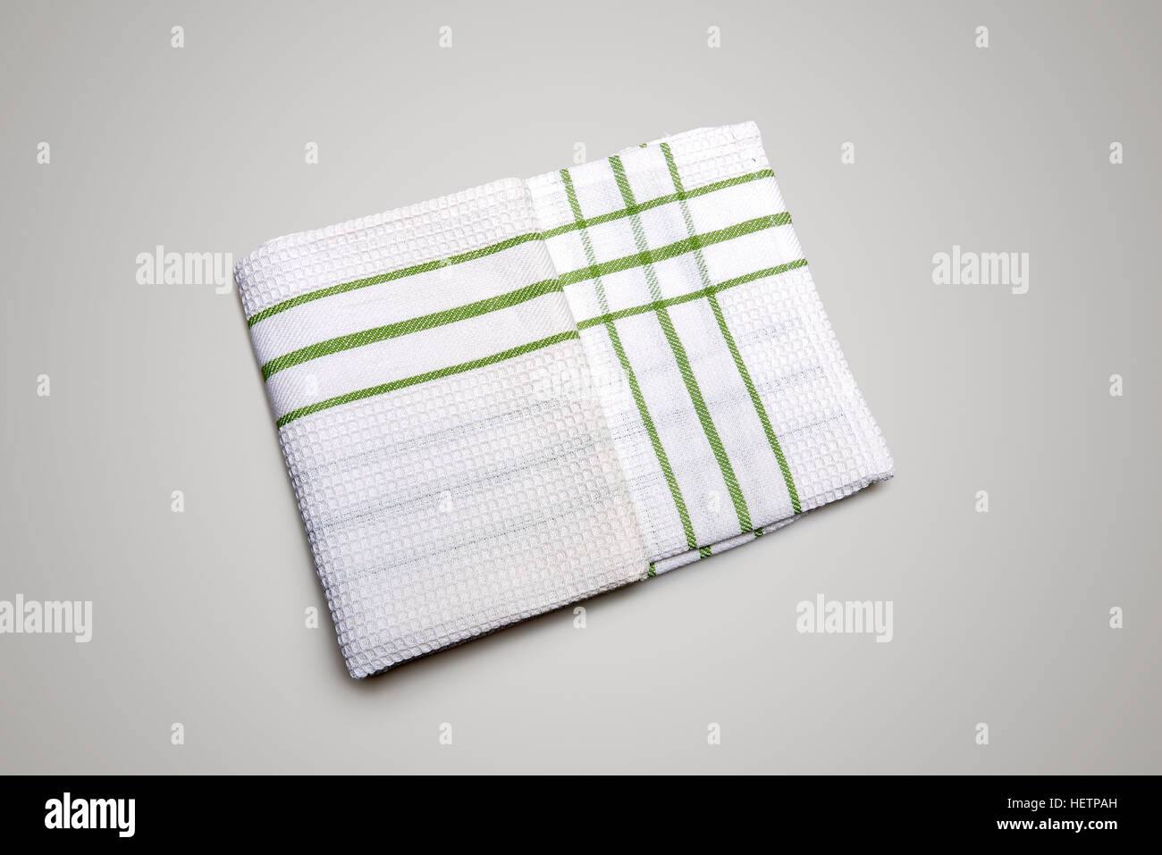 White Tablecloth made of linen with green stripes for the dish on a white background isolated Stock Photo