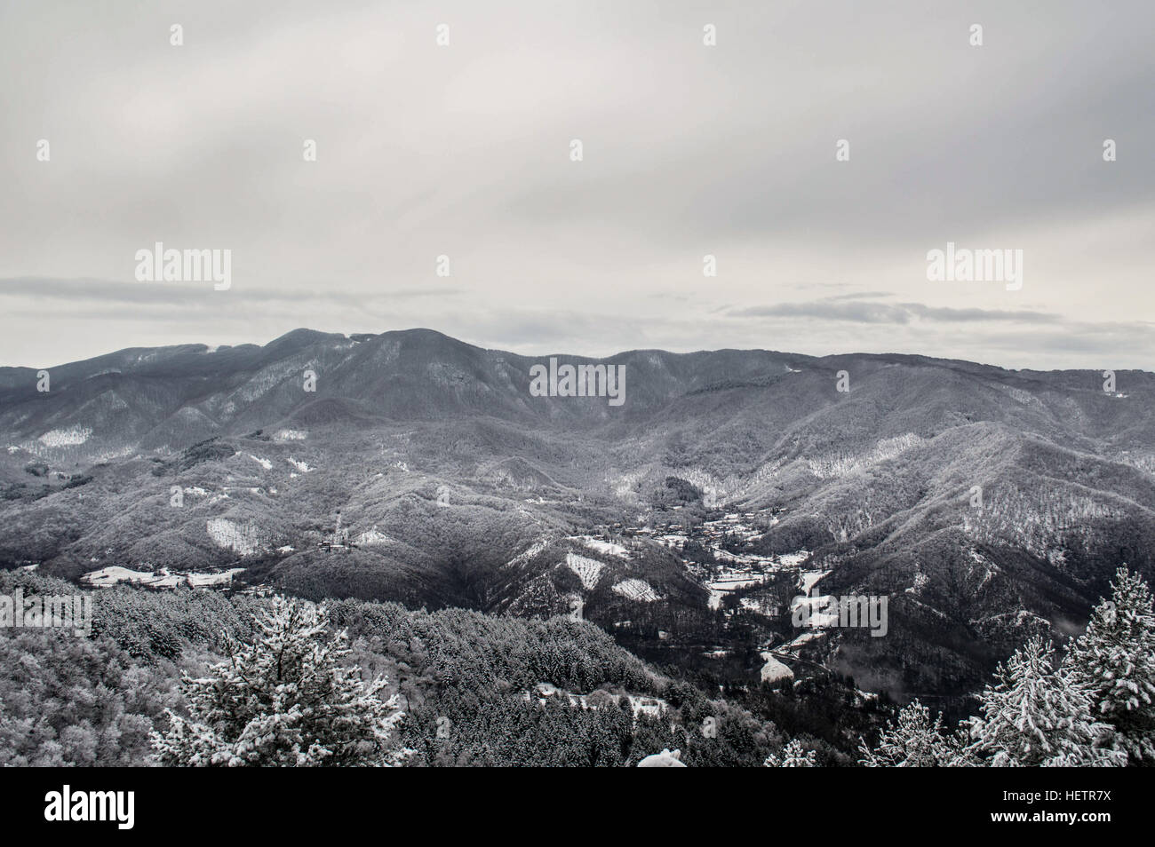 Almost a natural black and white landscape of the snowy mountains between Tuscany and Emilia-Romagna. Stock Photo