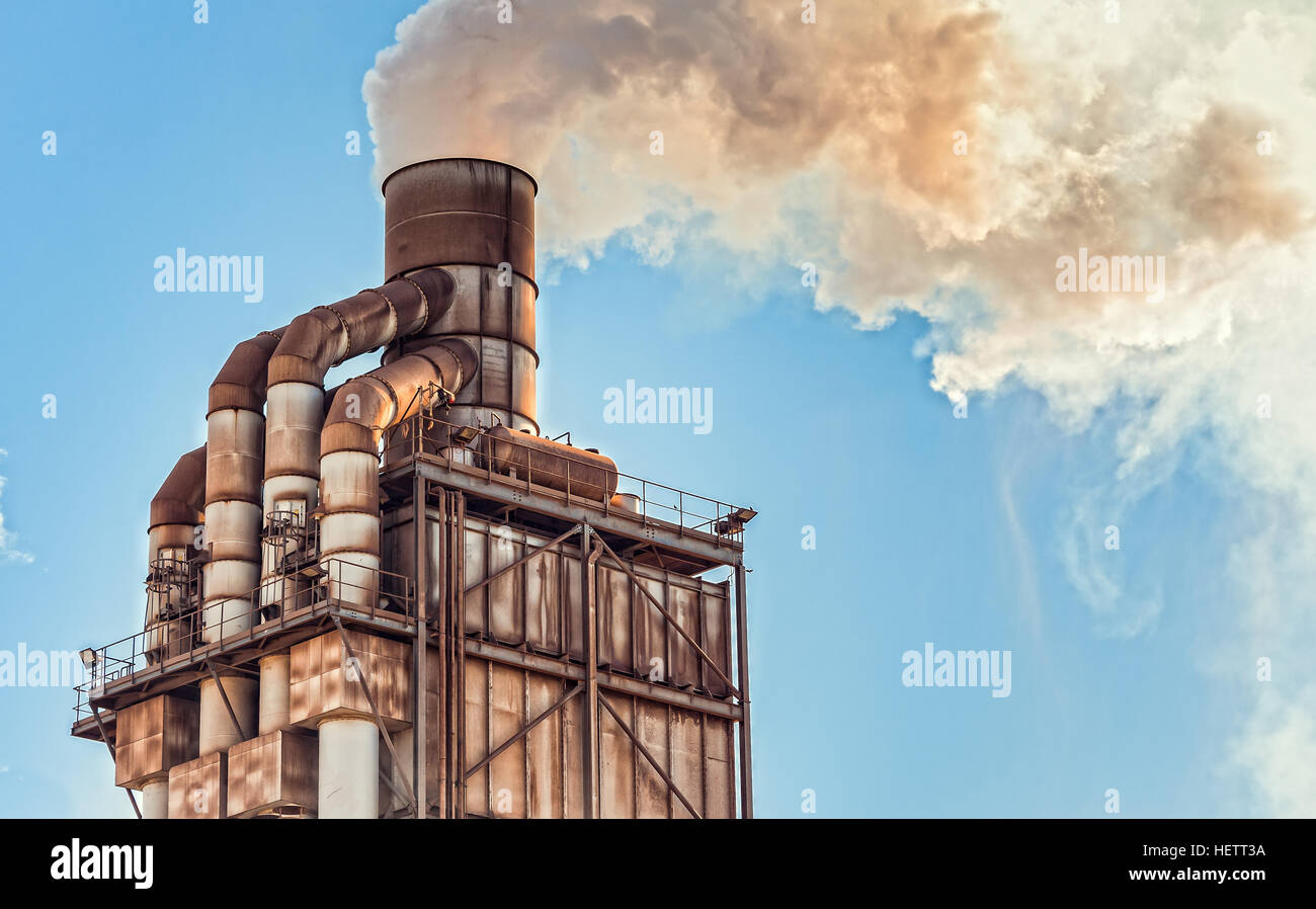 Pollution. Smoke from industrial chimney. Old smokestack of factory. Stock Photo