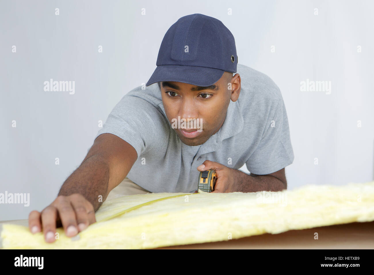 plasterer measuring a padding Stock Photo - Alamy