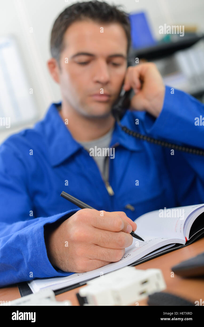 Making notes during a call Stock Photo - Alamy