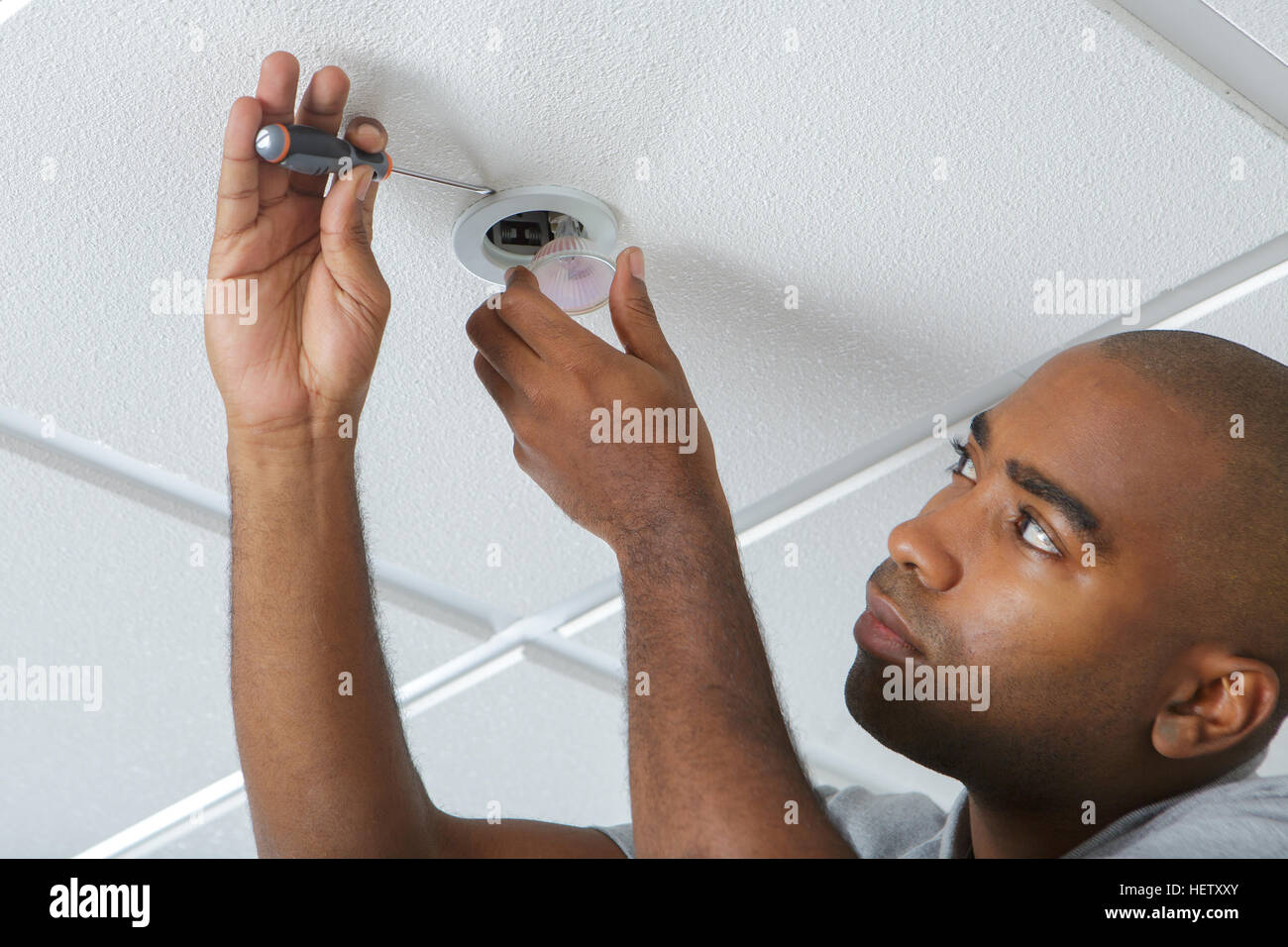 worker installing a smoke detector in a room Stock Photo Alamy