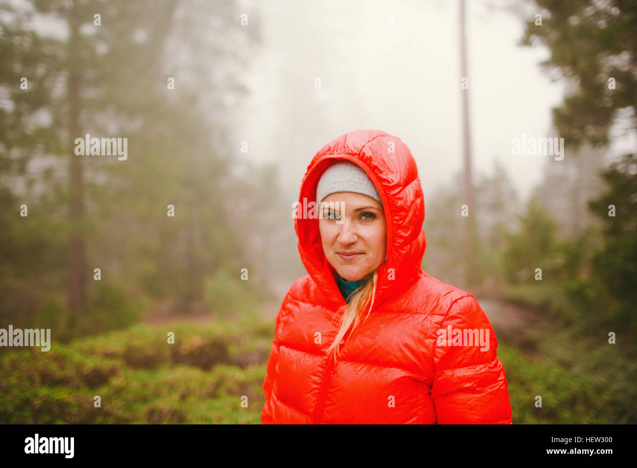 Woman in red hooded puffer jacket, Sequoia National Park, California, USA Stock Photo