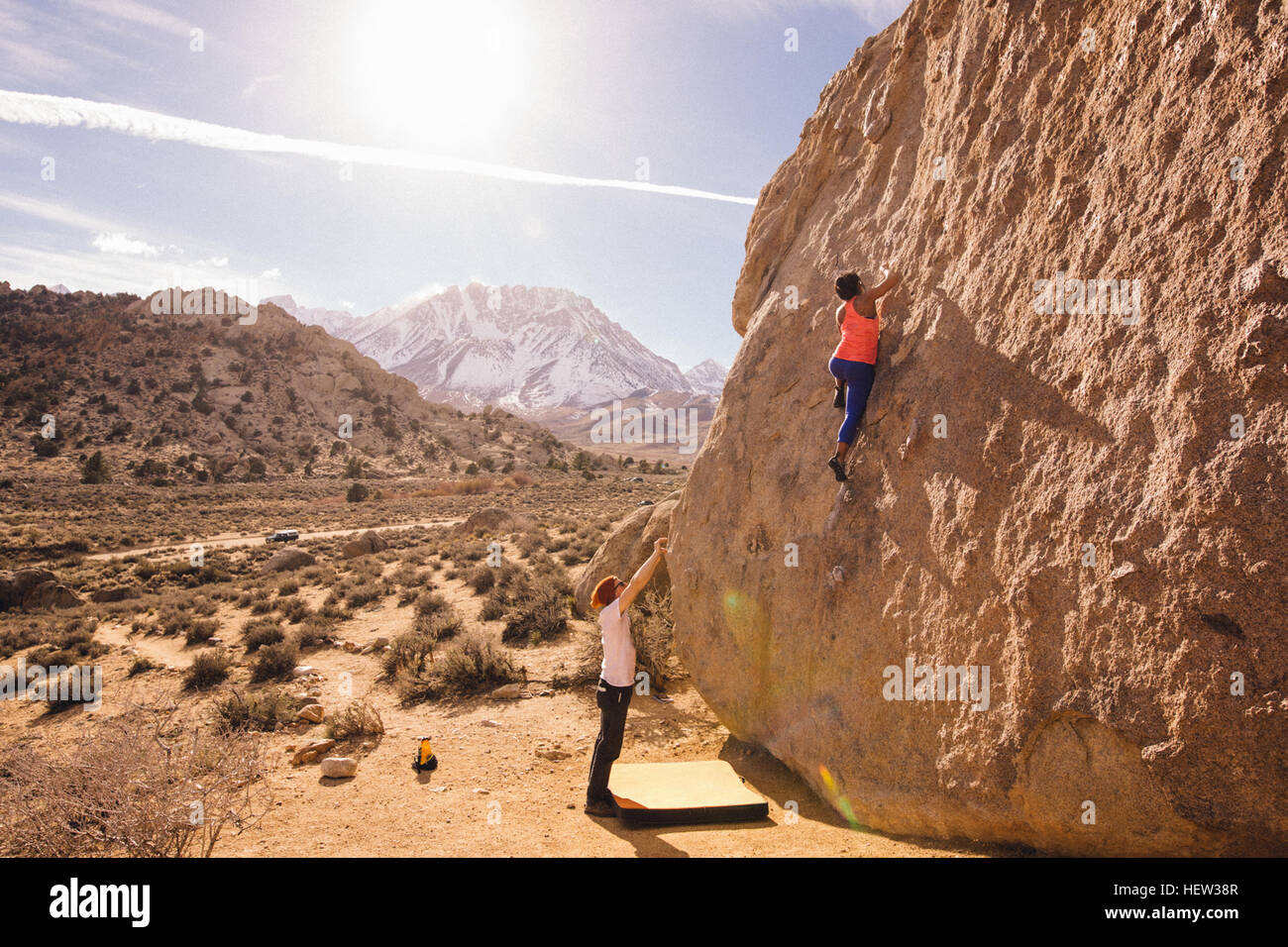 Couple climbing rock face, Buttermilk Boulders, California, USA