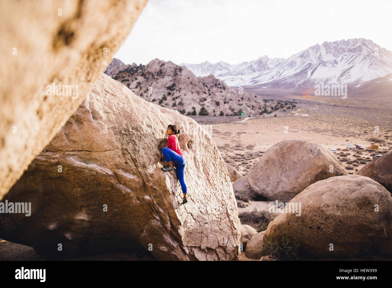 Woman rock climbing, Buttermilk Boulders, Bishop, California, USA Stock Photo
