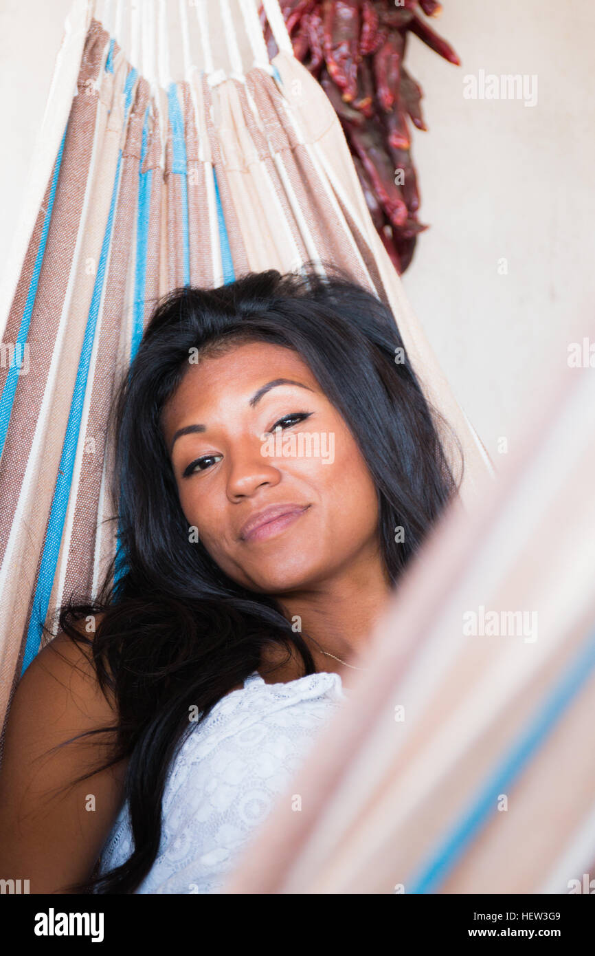 Portrait of young woman relaxing in hammock Stock Photo - Alamy