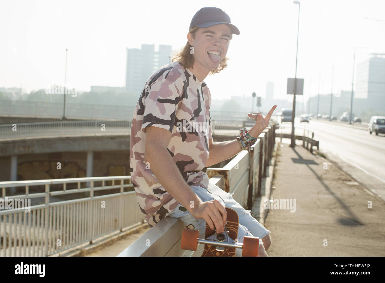 Skateboarder sticking tongue out,  Budapest, Hungary Stock Photo
