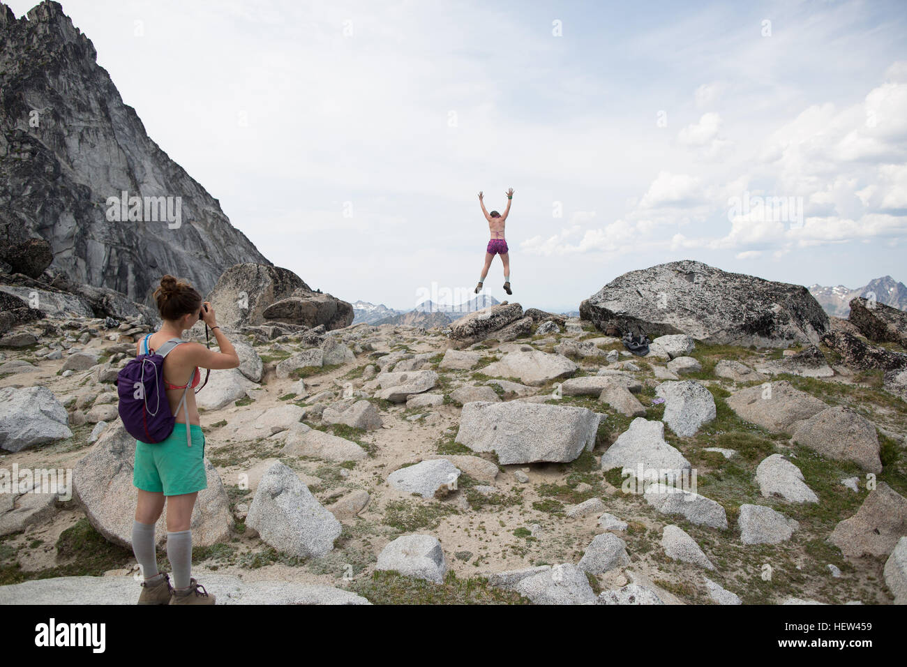 Young woman photographing friend, The Enchantments, Alpine Lakes Wilderness, Washington, USA Stock Photo