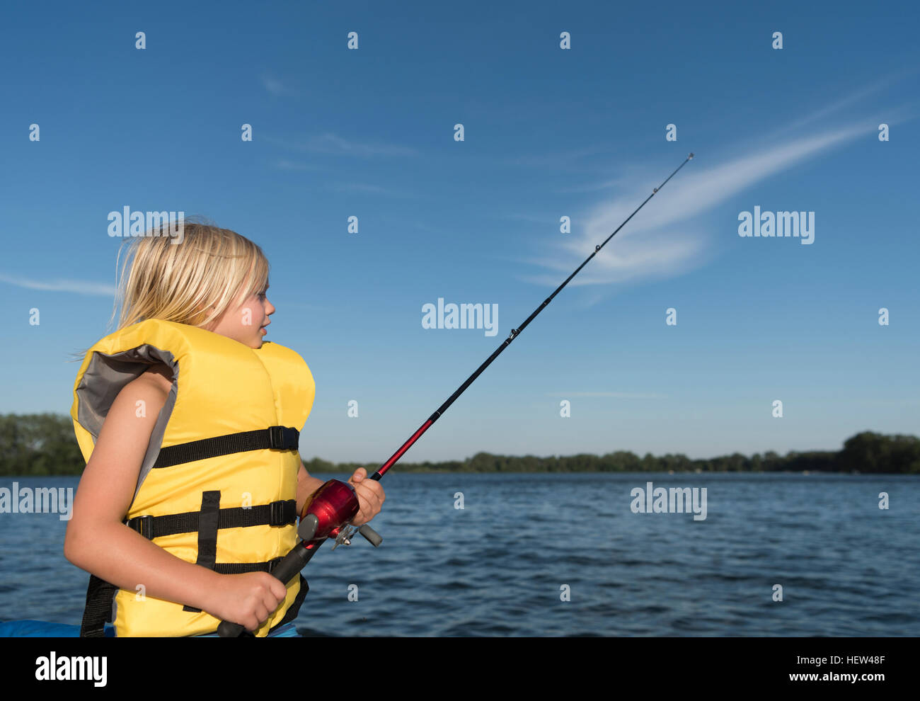 Boy wearing life jacket fishing Stock Photo Alamy
