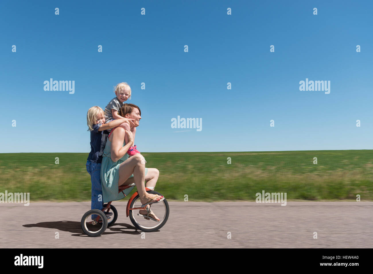 Boy riding his tricycle hires stock photography and images Alamy